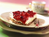 Piece of cheesecake with red berry compote