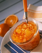 Peach and orange preserve in preserving jar