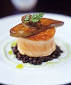 Goose liver on salmon with onion confit and basil oil