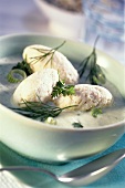Fish cakes in herb sauce with spring onions