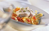 Red perch on tagliatelle with tomatoes