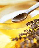 Honey in glass bowl with wooden spoon and lavender