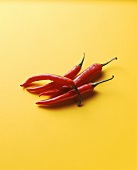 Red chilli peppers on yellow background