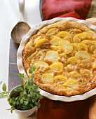 Potato pie with shallots in the baking dish