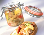 Pickled goose pieces in pickling jar and on bread