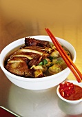 Asian noodle soup with fried chicken
