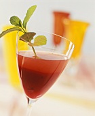 Cocktail with white wine, raspberry puree and fresh mint