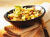 Indian coconut rice with vegetables, almonds and raisins