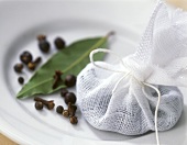 Various spices and bay leaf with muslin bags