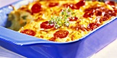 Vegetable casserole with tomatoes in blue baking dish