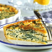 Piece of chard quiche on plate in front of baking dish