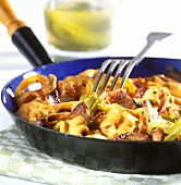 Strips of lamb (Geschnetzeltes) with gherkins in pan