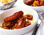 Sausages with pepper and onion sauce