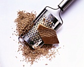 Piece of chocolate, grated chocolate and grater