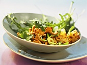 Chanterelle and bread salad with rocket and spring onions