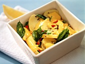 Potatoes with spicy cheese sauce and basil