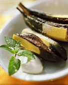 Baked chocolate bananas with cream and fresh mint