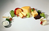 Various types of cheese with grapes arranged in an arc