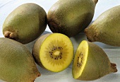 Yellow kiwi fruits, one halved