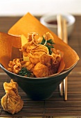Deep-fried wan tans in brown bowl