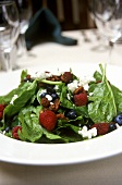 Spinach salad with berries, nuts and goat's cheese