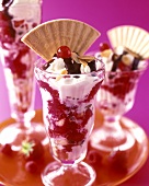 Ice cream sundae with berries, cream and wafer