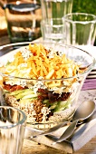 Layered salad with cereals, vegetables and cheese for picnic