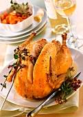Stuffed roast chicken, carved; carrots; white wine