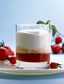 Tomato puree with head of white foam in glass