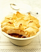 Queen of puddings: raspberry meringue pudding in baking dish