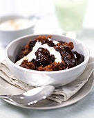 Sticky toffee pudding with chocolate sauce and cream