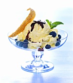 Vanilla ice cream with blueberries and chocolate sauce