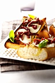 Garlic baguette with mozzarella and dried tomatoes