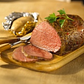 Roast beef, a slice cut, with baked potatoes