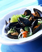 Mussels with vegetables in white dish