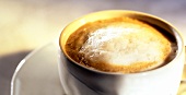 Coffee with milk froth in white cup