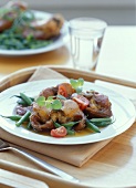 Rabbit cutlets with green beans, tomatoes and oregano