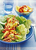 Potato and pepper salad with curry sauce on lettuce