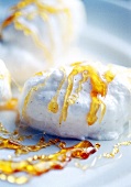 Snow eggs (poached meringues) with caramel sauce