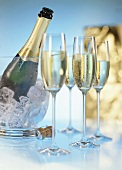 Champagne glasses and champagne bottle in cooler