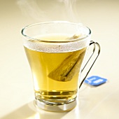 Hot chamomile tea with tea bag in glass