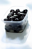 Black olives in plastic bowl