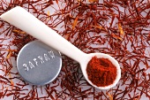 Saffron powder on spoon and saffron threads