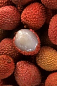 Lychees, one half-peeled (filling the picture)