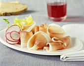 Schinkenspeck ham with radishes; red wine glass