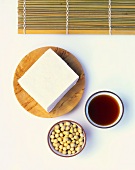 Slices of tofu, soya beans and soy sauce
