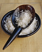 Boiled rice in bowl with spoon