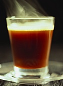 Steaming coffee in glass