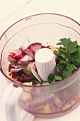 Red onions and coriander leaves in blender