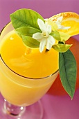 Glass of orange juice with orange blossom